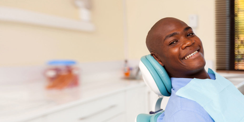 dental patient smiling after tooth extraction procedure