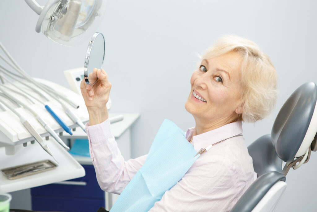An image of a woman at a dental office getting dental implants.